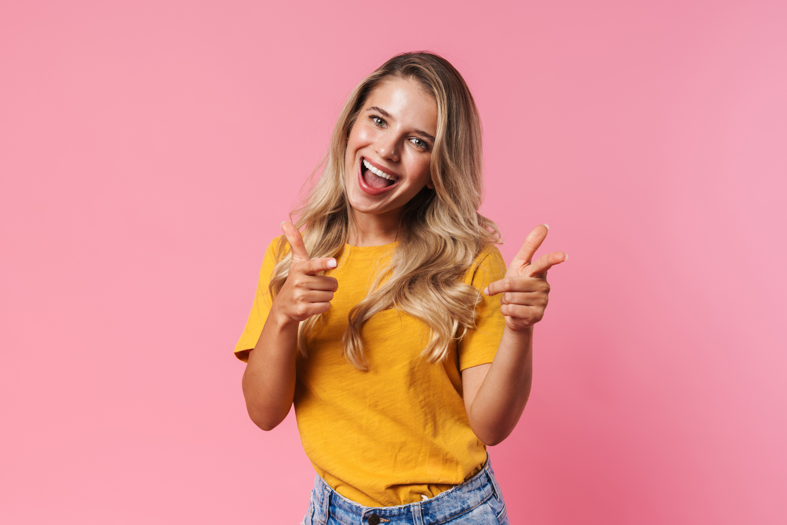 Positive Young Woman Pointing to You